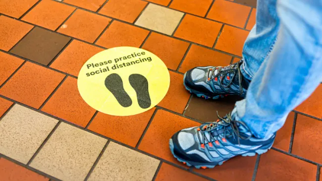 social distancing sign on floor